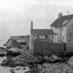 General view of rear of Gyles House, Pittenweem, over rocks.