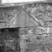 View of engraved triangular slab built into the masonry wall of Black Castle, South Queensferry.