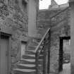View of stone staircase in courtyard, Black Castle, South Queensferry.