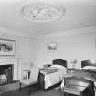 Interior view of Arbuthnott House showing bedroom with fireplace.