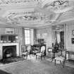 Interior view of Arbuthnott House showing drawing room with fireplace on first floor.