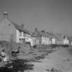 General view of 4-19 West Shore, PIttenweem, showing retaining wall and beach.