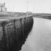 General view of quay wall and The Lobster Pot behind, Eyemouth.