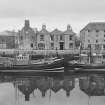 General view of The Ship Hotel, Eyemouth from E, showing fishing boats in harbour.