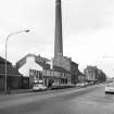 Stoddart's Carpet Factory (St Mirren's Works), Caledonia Street, Paisley, Renfrewshire
View from SSE showing factory chimney with E front of public house in middle foreground