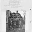 Photographs and research notes relating to graveyard monuments in Lundie Churchyard, Angus. 
