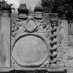 View of gravestone on north wall of Culross Abbey graveyard with barleysugar column.