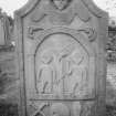 View of gravestone commemorating Margaret McConacher, d.1784, with winged soul, Adam and Eve, crossed bones, skull, coffin and hourglass, in the churchyard of Logierait Parish Church.
