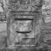 View of W face of headstone commemorating J.V. and M.J., 1726, in the churchyard of Bo'ness Parish Church,  showing maltman's spade, box above, and soul with leafy wings at top.