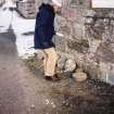 View of unprovenanced stacking stones beside church; Mr Adam Welfare (RCAHMS) in picture