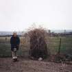 View of standing stone; Mr Adam Welfare (RCAHMS) in picture
