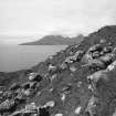 Eigg, Poll Duchaill, Fort. View from S of fragment of W wall.