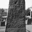 View of reverse of Aberlemno no 2, the Churchyard Stone, showing Pictish symbols and battle scene.