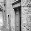 View of doorway to Aberdeen University Press, Aberdeen, with inscribed lintel and carved panel above.