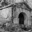 General view of exterior of well house, Bealach an Fhuarain, Inveraray Castle Estate, showing small stone building with pediment and vermiculated rustication over the arch entrance.