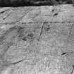 Cup and ring markings on lower sheet.