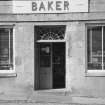 View of entrance to baker's shop, 'Malvern', 21-23 Low Street, Portsoy.
