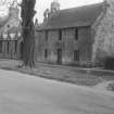 General view from NW of Fawn's Park and Old School House, Main Street, Ormiston.