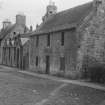 General view from NW of Fawn's Park and Old School House, Main Street, Ormiston.