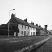 General view of High Street, Ayton, from N, including the old police station and clock tower on the left.