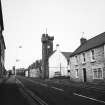 View of High Street, Ayton, from S, showing the old police station and clock tower on the right.