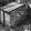 View of brick outhouse of an unidentified cottage.