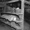 Interior.
Former byre, ground floor, detail of shelving.