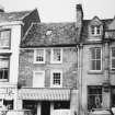 View of unidentified shop and W Millar on the right.