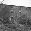 View from SW of SW side of mill, revealing that, despite its modest appearance from the road, it is four storeys high