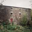 View from SW of SW side of mill, revealing that, despite its modest appearance from the road, it is four storeys high