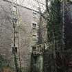 View from E of NE side of mill, with two arches of the tailrace visible (bottom foreground)