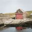 View from WSW of boat house and slipway, with harbour wall (left)