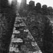 View of one of buttresses from retaining wall in front of house.