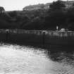 View of harbour with row of houses above.