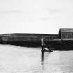 General view of harbour mouth showing the side of the boathouse.