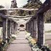 View of stone pergola and daffodil collection.