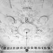 Interior. Former entrance hall plaster ceilng depicting suits of Roman armour