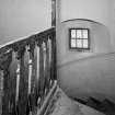 Interior, detail of main spiral staircase at attic level with flat balusters and newel