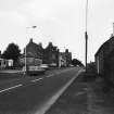 View down Main Street, showing The Wheatsheaf Hotel and Esso Garage.