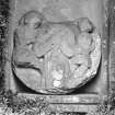 Detail of carved roundel in niche set into wall of formal garden.