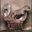 Detail of sculptural figure in niche set into wall of formal garden.