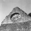 Detail of W gable of refectory showing rose window.