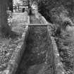 View from N along lade (empty, but currently being repaired), looking towards mill.