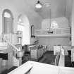 Interior. View from NE showing pulpit, pews and W gallery