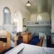 Interior. View from NE showing pulpit, pews and W gallery