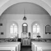 Interior. View from NNW in N aisle showing archway and central pulpit