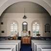 Interior. View from NNW in N aisle showing archway and central pulpit