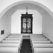 Interior. View from SSE showing N aisle with stained glass window