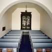 Interior. View from SSE showing N aisle with stained glass window