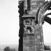 Detail of aisle chapel buttress with royal arms of James IV.